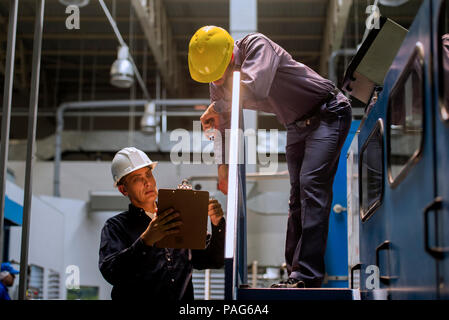 Factory workers with clipboard in factory Stock Photo