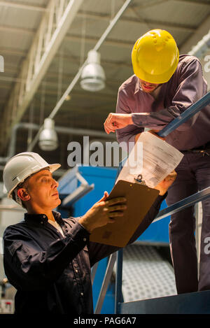 Factory workers with clipboard in factory Stock Photo
