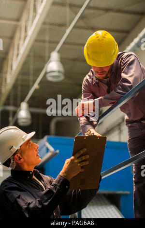 Factory workers with clipboard in factory Stock Photo