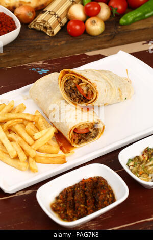 Tortilla wrap with meat and french fries. Turkish Shawarma Doner durum Stock Photo