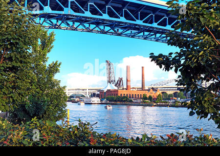 Revitalized rustbelt infrastructure on the West Bank of the Flats can be seen from across the Cuyahoga River in downtown Cleveland, Ohio, USA. Stock Photo