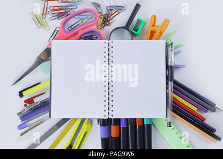 opened Notepad on office supplies on white background Stock Photo