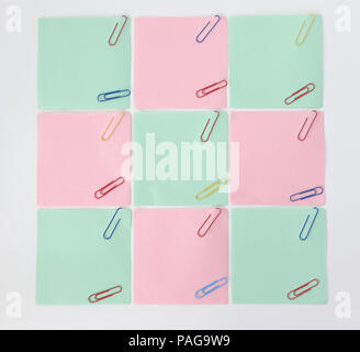 multiple blank sheets for notes with paper clips isolated on whi Stock Photo