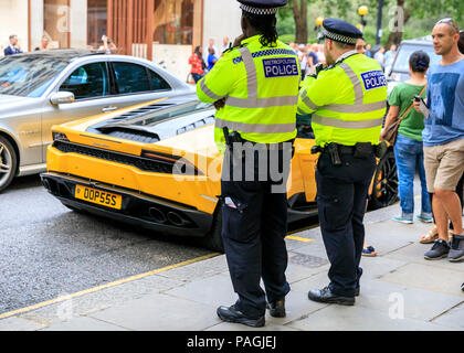 Sloane Street, London, UK, 20th July 2018. A red Lamborghini tries to steal  the show. Supercars, high-performance and classic cars, as well as some  characterful adaptions, line up and drive along Sloane Street for Supercar  Sunday, which sees around 400