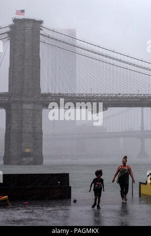 New York, USA. 22nd July, 2018. People walk in the pouring rain in Manhattan of New York City, the United States, July 22, 2018. Credit: Li Muzi/Xinhua/Alamy Live News Stock Photo