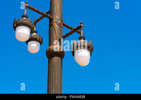 Street lamp against the blue sky in Sitges, Barcelona, Catalunya, Spain. Copy space for text. Isolated on blue background. Close-up Stock Photo