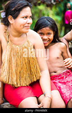 AMAZONIA, PERU - NOV 10, 2010: Unidentified Amazonian indigenous woman and her daughter. Indigenous people of Amazonia are protected by COICA (Coordin Stock Photo
