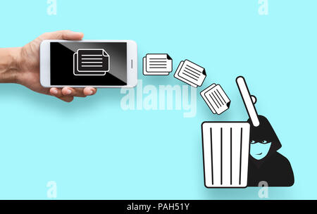 business hand throw data file from mobile to trash bin Stock Photo