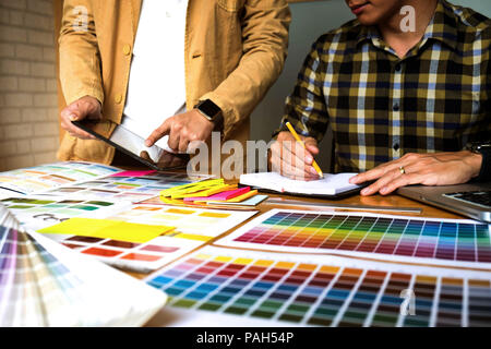 Graphic designers use the tablet to choose colors from the color bar ...
