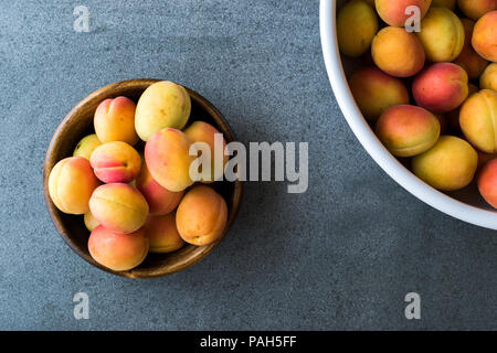 Raw Ripe Organic Orange Apricots in Wooden Bowl. Organic Food. Stock Photo