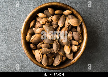 Dried Apricot Kernels in Wooden Bowl. Organic Product. Stock Photo