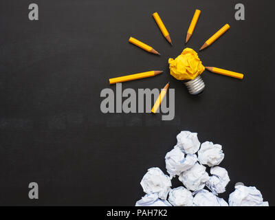 Pencils with yellow crumpled paper on a chalkboard, abstract business or creativity concept Stock Photo