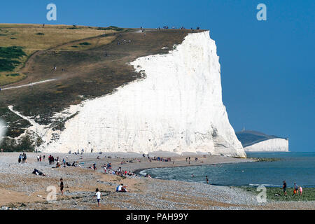 The shingle beach at Cuckmere Haven at high tide with the estuary of ...