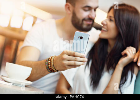 Picture showing romantic couple dating in cafe and taking selfie Stock Photo