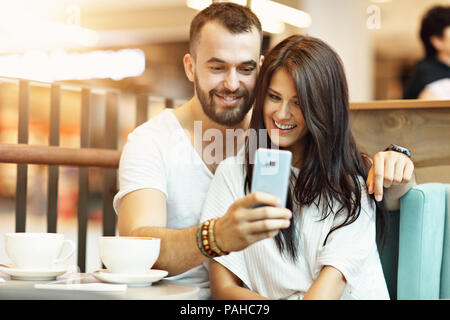 Picture showing romantic couple dating in cafe and taking selfie Stock Photo