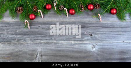 Overhead view of real fir Christmas tree branches with decorations on weathered wood Stock Photo