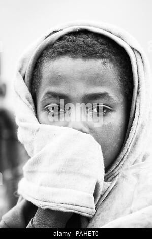 OMO VALLEY, ETHIOPIA - SEP 22, 2011: Unidentified Ethiopian little boy wearing old clothes in Ethiopia, Sep.22, 2011. Children in Ethiopia suffer of p Stock Photo