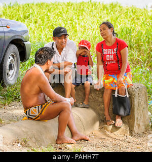EMBERA VILLAGE, PANAMA, JANUARY 9, 2012: Unidentified Panamanaian Indian speaks to the tourists in Panama, Jan 9, 2012. Indian reservation is the way  Stock Photo