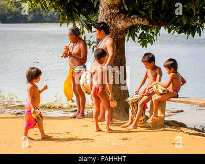 EMBERA VILLAGE, PANAMA, JANUARY 9, 2012: Unidentified native Indian family make music for tourists  in Panama, Jan 9, 2012. Indian reservation is the  Stock Photo