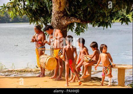 EMBERA VILLAGE, PANAMA, JANUARY 9, 2012: Unidentified native Indian family make music for tourists  in Panama, Jan 9, 2012. Indian reservation is the  Stock Photo