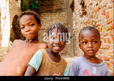 GHANA - MARCH 2, 2012: Three unindentified Ghanaian children smile for the camera in Ghana, on March 2nd, 2012. People in Ghana suffer from poverty du Stock Photo