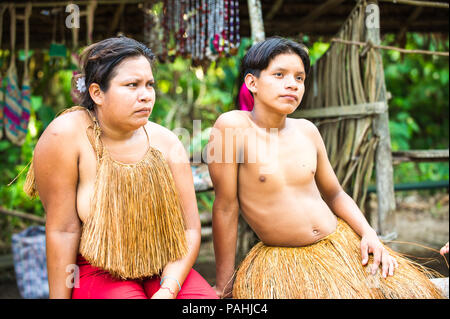 AMAZONIA, PERU - NOV 10, 2010: Unidentified Amazonian indigenous family. Indigenous people of Amazonia are protected by COICA (Coordinator of Indigeno Stock Photo