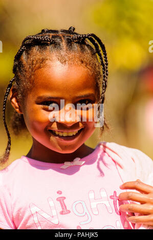 MADAGASCAR - JUNE 27, 2011: Unidentified Madagascarian girl smiles for the camera in Madagascar, June 27, 2011. Children of Madagascar suffer of pover Stock Photo