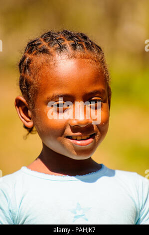 MADAGASCAR - JUNE 27, 2011: Unidentified Madagascarian girl smiles for the camera in Madagascar, June 27, 2011. Children of Madagascar suffer of pover Stock Photo