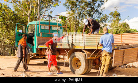 ANTANANARIVO, MADAGASCAR - JUNE 27, 2011: Unidentified Madagascar people destroy the truck. People in Madagascar suffer of poverty due to the slow dev Stock Photo