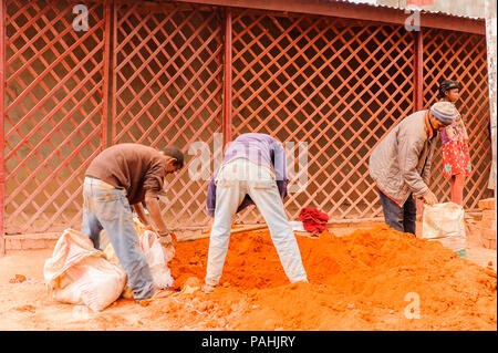 ANTANANARIVO, MADAGASCAR - JUNE 29, 2011: Unidentified Madagascar people get the sand. People in Madagascar suffer of poverty due to the slow developm Stock Photo