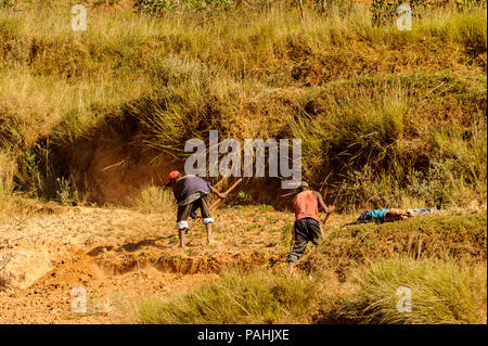 ANTANANARIVO, MADAGASCAR - JUNE 29, 2011: Unidentified Madagascar people dig the sand. People in Madagascar suffer of poverty due to the slow developm Stock Photo