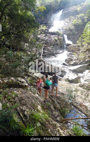 Adventurous young women arrive at Home Rule Falls, Cedar Bay National Park, Queensland, Australia. No MR Stock Photo