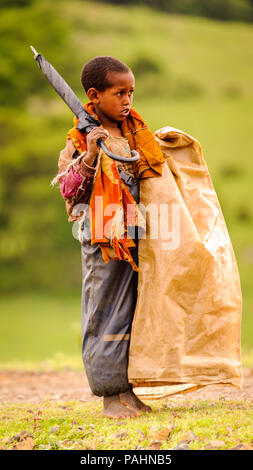 OMO VALLEY, ETHIOPIA - SEP 22, 2011: Unidentified Ethiopian little boy wearing old clothes in Ethiopia, Sep.22, 2011. Children in Ethiopia suffer of p Stock Photo