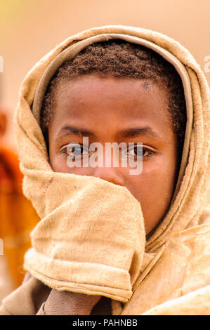 OMO VALLEY, ETHIOPIA - SEP 22, 2011: Unidentified Ethiopian little boy wearing old clothes in Ethiopia, Sep.22, 2011. Children in Ethiopia suffer of p Stock Photo