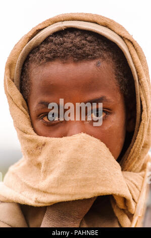 OMO VALLEY, ETHIOPIA - SEP 22, 2011: Unidentified Ethiopian little boy wearing old clothes in Ethiopia, Sep.22, 2011. Children in Ethiopia suffer of p Stock Photo