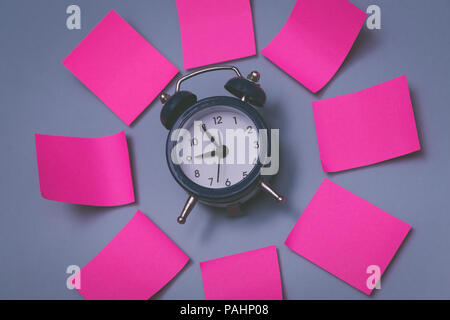 Pink sticky notes and clock, memory concept background. Stock Photo