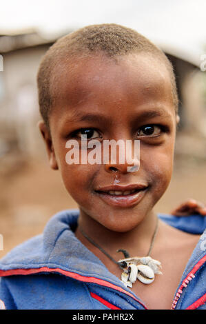 AKSUM, ETHIOPIA - SEP 27, 2011: Portrait of an unidentified Ethiopian child wearing old clothes in Ethiopia, Sep.27, 2011. Children in Ethiopia suffer Stock Photo