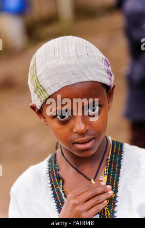 AKSUM, ETHIOPIA - SEP 27, 2011: Portrait of an unidentified Ethiopian little girl with a golden cross in Ethiopia, Sep.27, 2011. Children in Ethiopia  Stock Photo