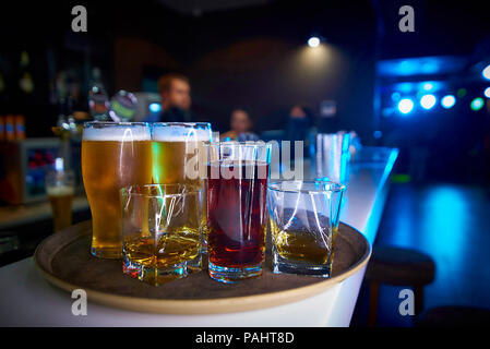 Drinks on the tray are on the bar. Stock Photo