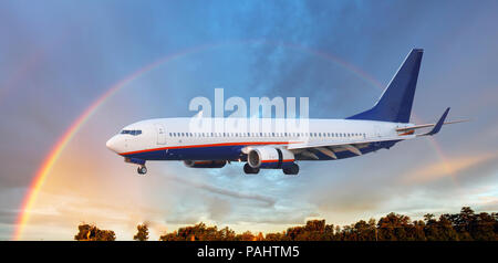 Landing airplane in Airport with rainbow Stock Photo