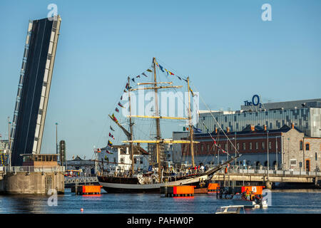 The British tall ship Pelican of London sailing on the Liffey river out to Dublin bay through the raised toll bridge East Link Stock Photo