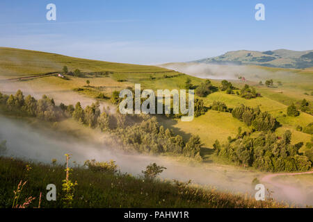 Beautiful and secluded landscape on a misty morning in the Apuseni Mountains near Salciua, Romania. Stock Photo