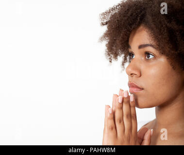 Portrait beautiful black woman praying, young girl with her hands together, closeup expression. Religion faith and believe concept banner Stock Photo