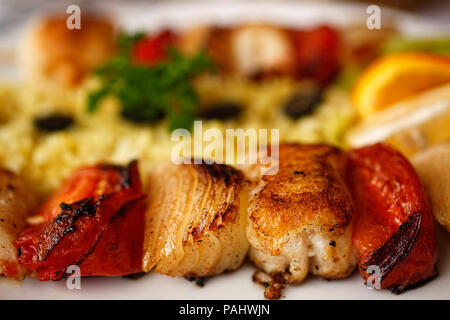 Close up of a juicy Maroccan fish skewer with vegetables Stock Photo