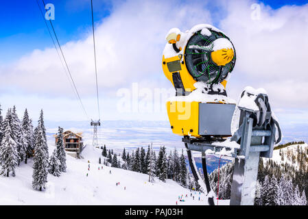 Snow cannon machine blowing artificial snow on Azuga ski domain, Prahova  Valley region, Romania, during the Winter low season, due to the lack of  natu Stock Photo - Alamy