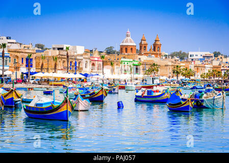 Malta. Traditional eyed colorful boats Luzzu in the Harbor of fishing village Marsaxlokk, Mediterranean Sea. Stock Photo