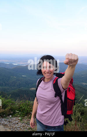 happy hiker woman to get to the top Stock Photo