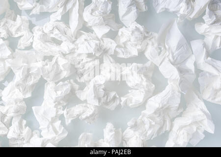 Many used screwed paper tissue on white background - close up Stock Photo