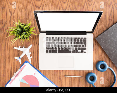 Top view of business man laptop on wooden .headphones , pot of grass  Stock Photo