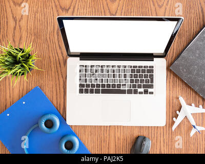 traveler  business man concept image on wooden desk ,headphones , pot of grass  Stock Photo